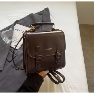 Nahaufnahme eines Vintage-Rucksacks aus dunkelbraunem Leder mit goldener Beschriftung