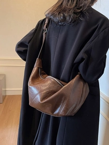 Dark brown pleated leather crescent shoulder bag with adjustable strap and silver zipper