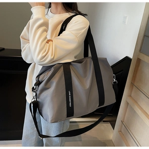 Vue détaillée du tissu en nylon imperméable, des poignées et des boucles en métal du sac