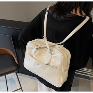 Detail view of cream white PU leather versatile backpack with adjustable shoulder straps