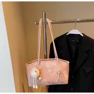 Close-up of pink marble texture tote bag with plush charm and Chris2ab branding