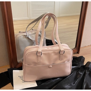 Detail of glossy pink and grey tote bags with embossed logo in a mirror reflection view