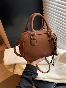 Vintage brown frosted leather cylinder bag with double handles and metallic bell charm