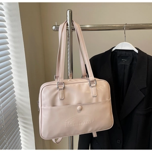 Detail of light pink PU leather bag with magnetic snap pocket and debossed logo