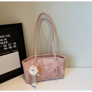 Detail of light pink marble tote bag with long straps and white fluffy ball pendant