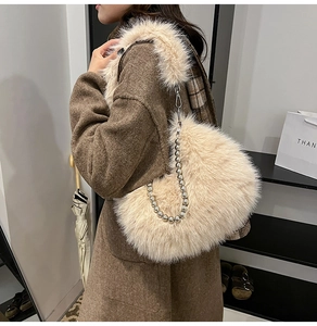 Detailed view of cream faux fur handbag featuring elegant silver spherical metal chain