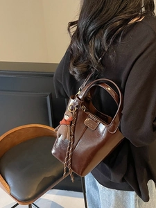 Retro dark brown bucket bag with oil-wax texture, bear charm and adjustable strap