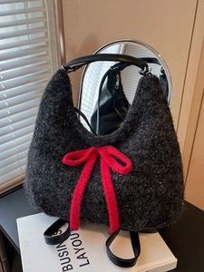 Chic black plush tote bag with silver glitter thread and a large red ribbon bow