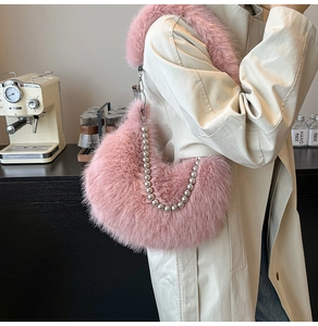 Detail of pink faux fur crossbody bag with elegant silver pearl metal chain decoration