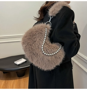 Detail of heart-shaped faux fur shoulder bag in brown with premium pearl chain strap