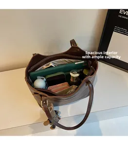 Macro view showing spacious interior with multiple pockets in this brown leather tote bag