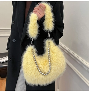 Close-up of yellow fluffy plush shoulder bag featuring decorative silver bead chain