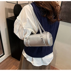 Detailed back view of a silver cylinder underarm bag with buckle straps and side pocket