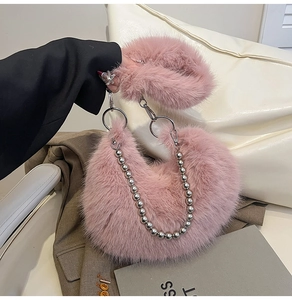 Detail of pink faux fur crescent bag featuring silver hardware and pearl bead chain