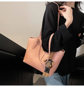 Pink tote bag detail with fashion leather gold lettering and cute bunny pendant