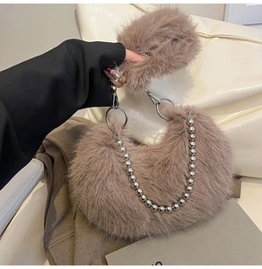 Detailed macro view of the taupe faux fur handbag featuring silver bead chain and hardware