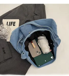 Spacious denim tote bag interior showing capacity for tablet, phone, and essentials