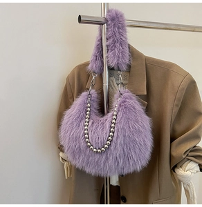 Detailed macro view of purple faux fur handbag featuring elegant silver beaded metal chain