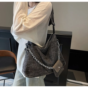 Detail of dark grey washed fabric tote bag with silver chain strap and mini pouch