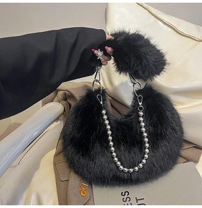 Detail view of plush black faux fur shoulder bag with decorative silver pearl chain