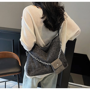 Detail of grey felt tote bag with silver chain and a matching small detachable square pouch