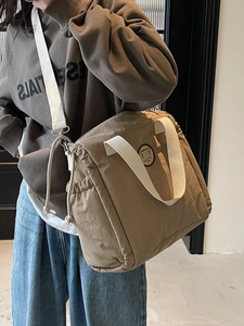 Versatile khaki canvas tote bag with adjustable shoulder strap and cute bear logo