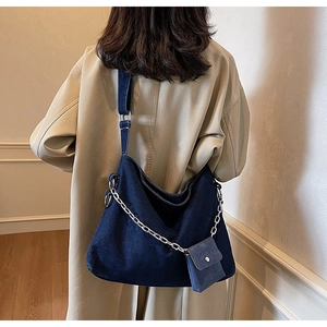 Detail of blue denim hobo bag with silver chain strap and mini detachable coin purse