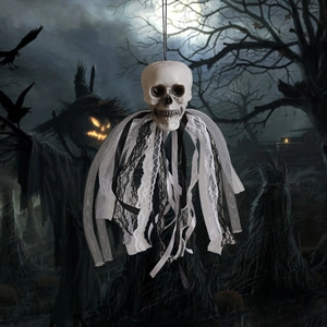 Detailed view of Halloween skull hanging prop with black and white lace ribbons in gothic style