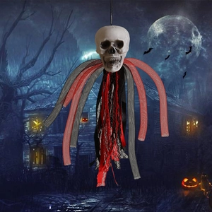 Spooky Halloween skull hanging decoration with red and black lace mesh in eerie night scene