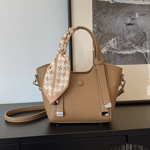 Brown textured leather crossbody bag with silk scarf handle and silver hardware