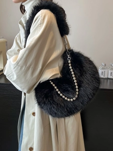 Black faux fur crescent shoulder bag with silver pearl chain and plush strap detail