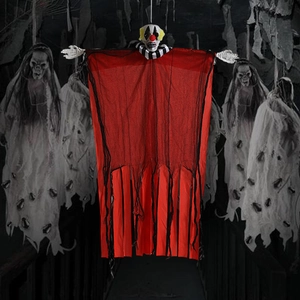 Hanging Halloween clown decoration with red mesh fabric and skull hands in spooky woods