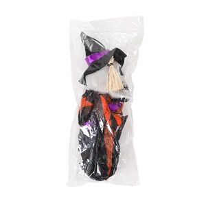 Detail of Halloween skeleton doll with wizard hat and broom in clear plastic packaging