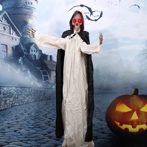 Close-up of Halloween ghost prop with glowing red LED eyes and layered fabric robes