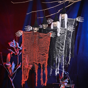 Detailed close-up of hanging Halloween witches with gauze robes and skull hands