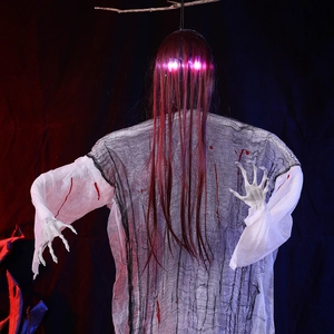 Close-up of Halloween hanging ghost with glowing head, red hair and skeleton hands