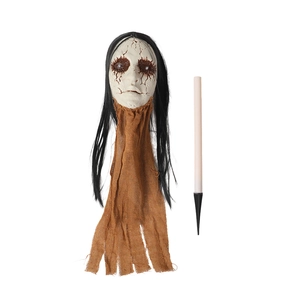 Close-up of Halloween scary skull head with long hair and brown burlap on a plastic ground stake