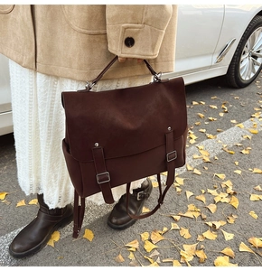 Deep brown matte backpack for women shown in an outdoor street scene with autumn leaves