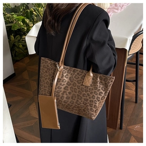 Detail of leopard print suede tote bag with a matching brown accessory pouch attached