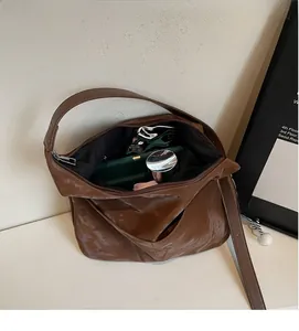 Spacious interior of a brown hobo bag showing capacity for daily essentials