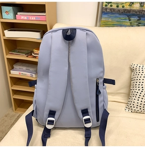 Detail view of the breathable padded shoulder straps and back anti-theft zipper of this blue backpack