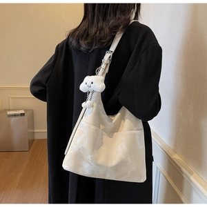 Detail of hobo shoulder bag in cream white with marble pattern and cloud charm