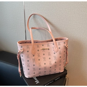 Detailed view of pink tote bag featuring bear patterns and lychee texture finish