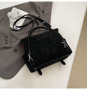 Detailed shot of black matte texture backpack with silver hardware and detachable strap