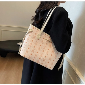 Detail of pink tote bag with cartoon bear pattern and adjustable side drawstring feature