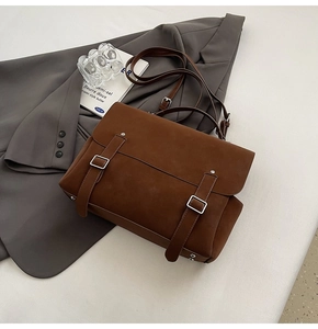 Detail of vintage brown frosted backpack featuring silver metal buckles and suede texture