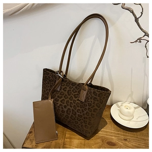 Detail of leopard print suede tote bag with leather straps and matching pouch