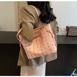 Detailed close-up of pink tote bag with bear print, gold plaque, and drawstring detail