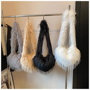 Close-up of fluffy faux fur crossbody bags in gray, apricot, black and white colors
