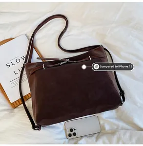 Deep brown oversized suede tote bag shown with an iPhone 12 for size comparison